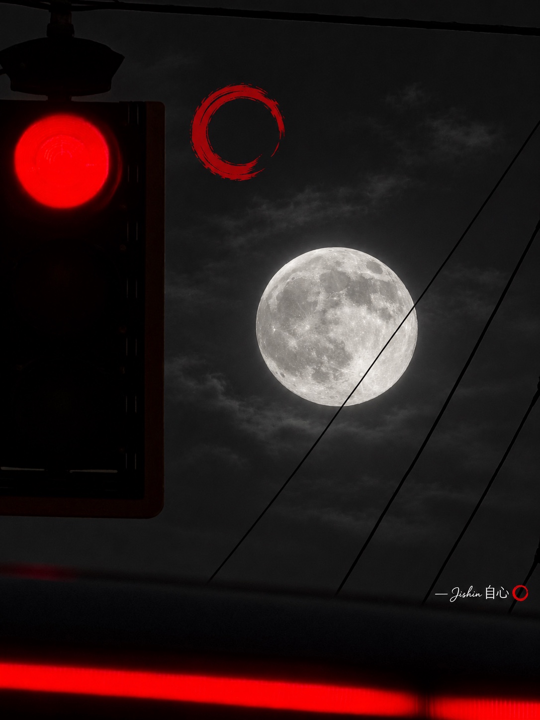 A full moon crossed by diagonal utility wires, beside a red signal light and red ensō, in black and white with selective red color