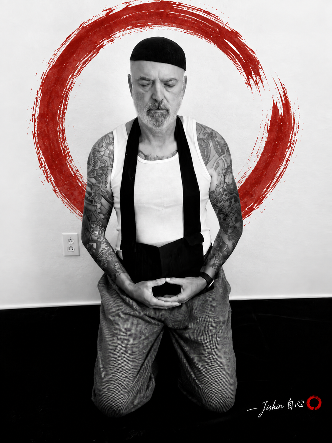 John Michael Cobb seated in meditation on a seiza bench, in black and white with a red brushstroke ensō